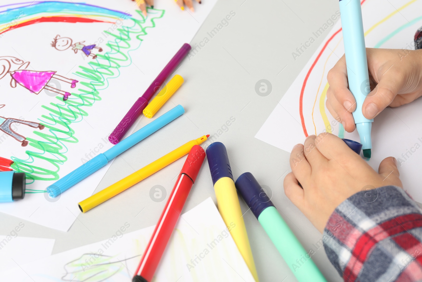 Photo of Boy drawing picture at light table, closeup