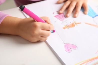 Photo of Little girl drawing his family at white table, closeup