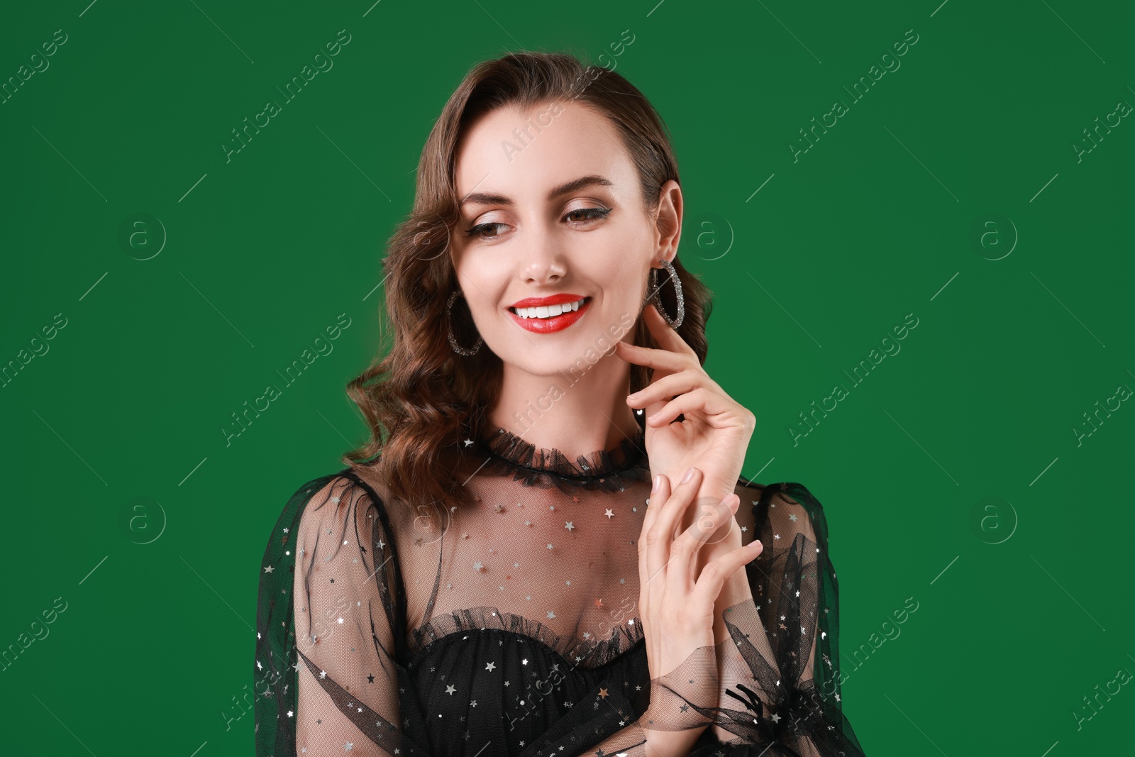 Photo of Portrait of smiling woman with perfect makeup on green background