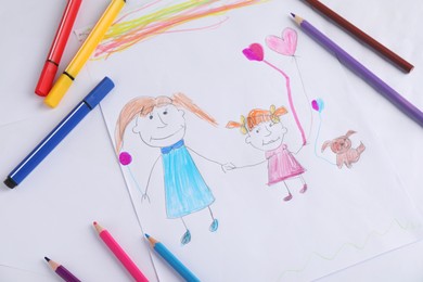 Photo of Child's drawing of happy family and supplies as background, top view