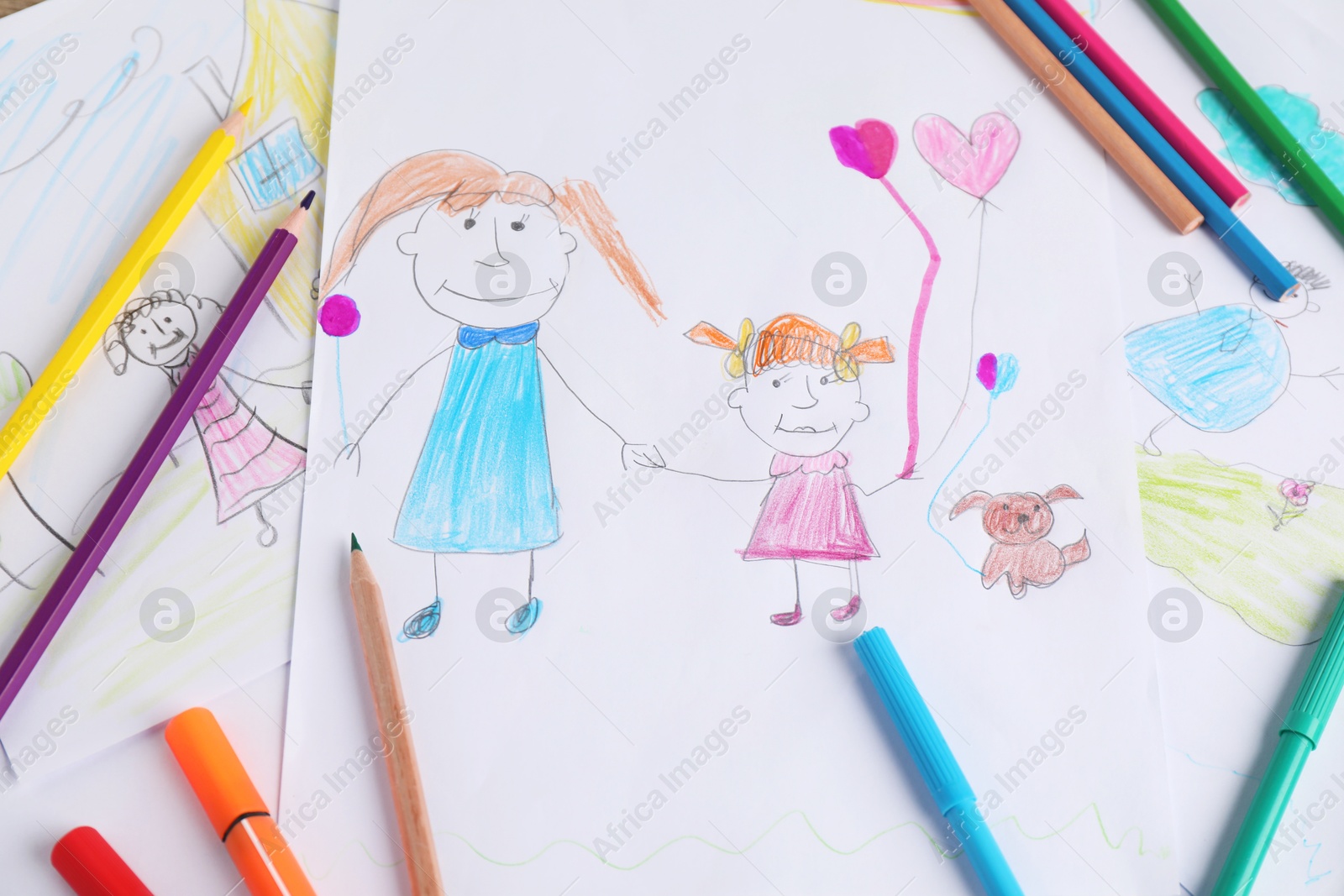 Photo of Child's drawing of happy family and supplies as background, top view