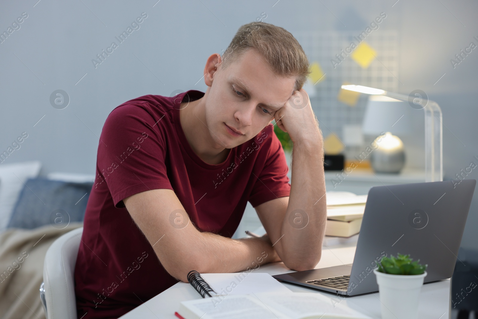 Photo of Student preparing for exam at table indoors