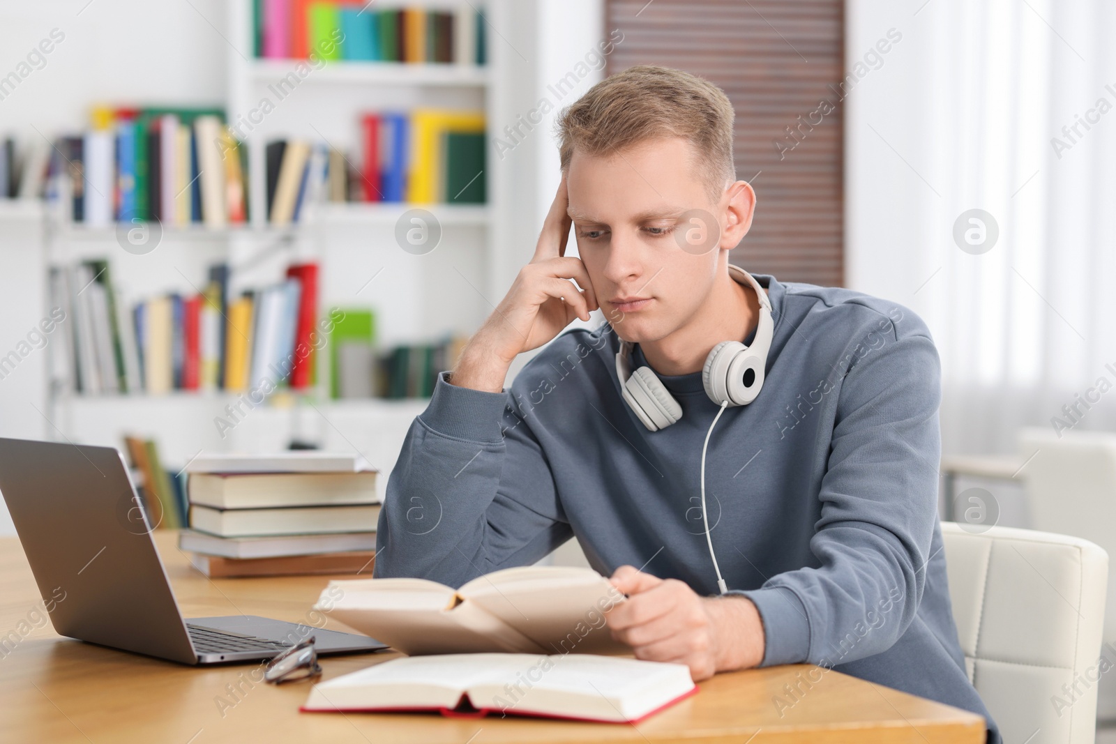 Photo of Student preparing for exam at table indoors