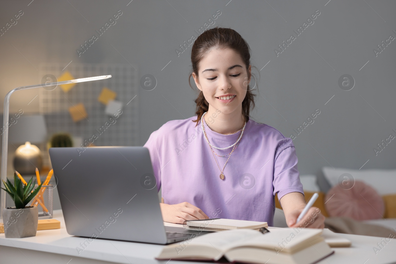 Photo of Student preparing for exam at table indoors