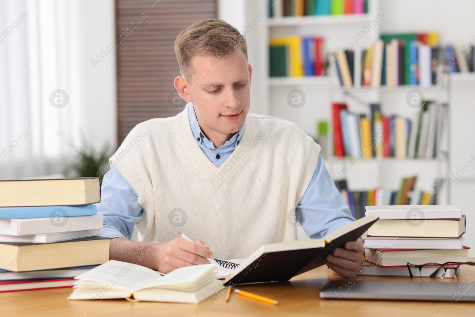 Photo of Student preparing for exam at table indoors