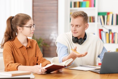 Students preparing for exam at table indoors