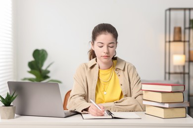 Photo of Student preparing for exam at table indoors