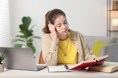 Photo of Student preparing for exam at table indoors