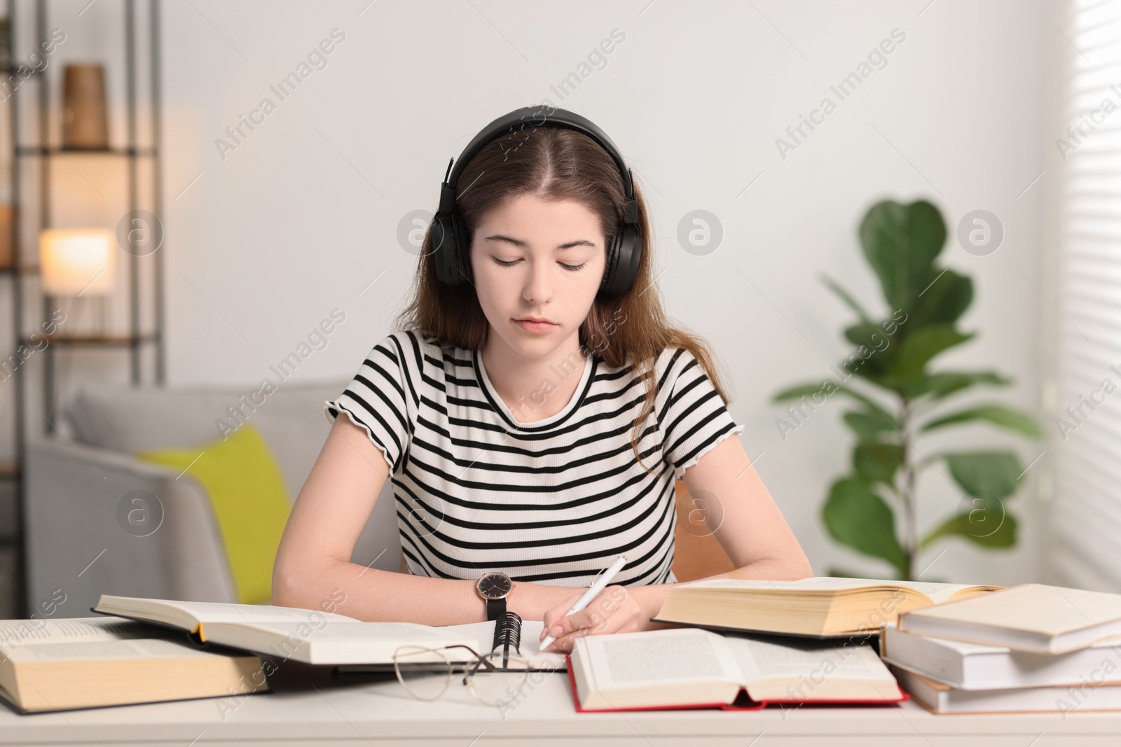 Photo of Student preparing for exam at table indoors