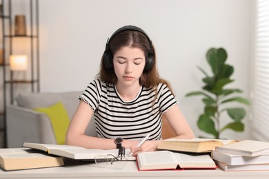 Photo of Student preparing for exam at table indoors