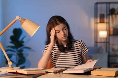 Photo of Student preparing for exam at table indoors