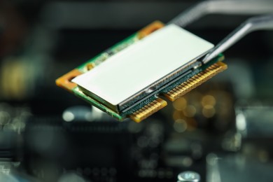 Photo of Wi-Fi card on blurred background, closeup. Electronic engineering