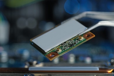 Photo of Wi-Fi card on blurred background, closeup. Electronic engineering