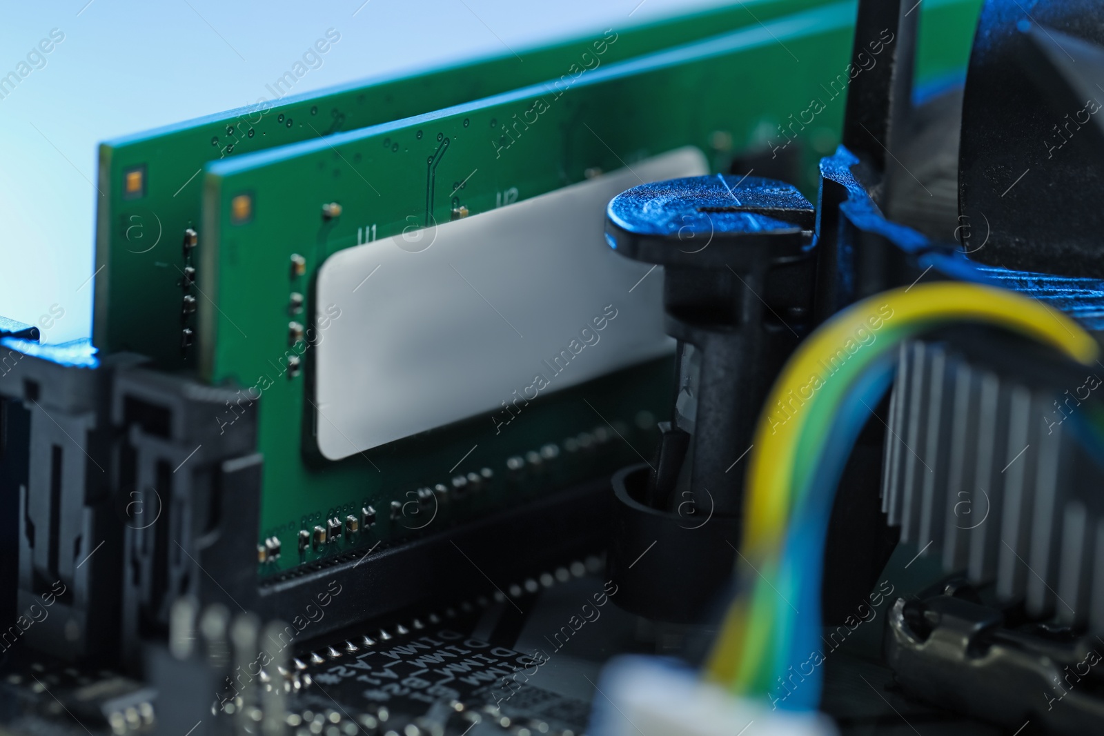 Photo of Computer motherboard with RAM chip as background, closeup. Electronic engineering