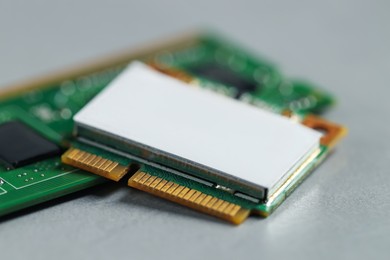 Photo of Wi-Fi card and RAM chip on grey table, closeup