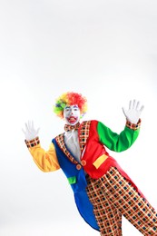 Photo of Portrait of emotional clown on light background