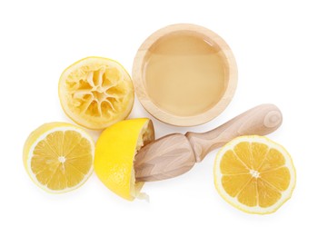 Photo of Fresh lemon juice in bowl, squeezer and fruits isolated on white, top view