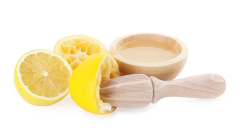 Photo of Fresh lemon juice in bowl, squeezer and fruits isolated on white