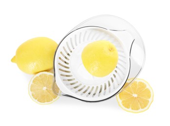 Photo of Juicer and fresh lemons isolated on white, top view