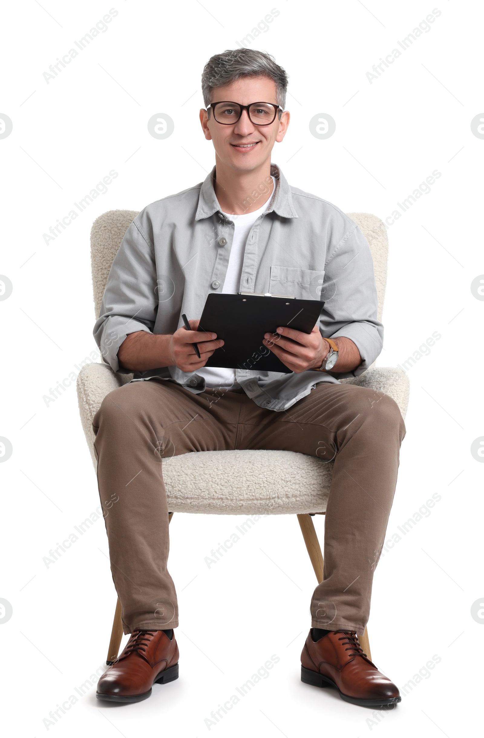 Photo of Professional psychologist with clipboard sitting on chair against white background