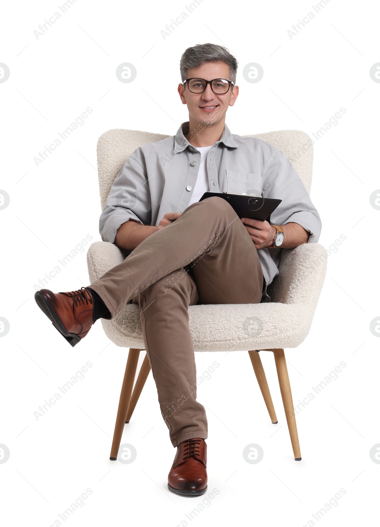 Photo of Professional psychologist with clipboard sitting on chair against white background