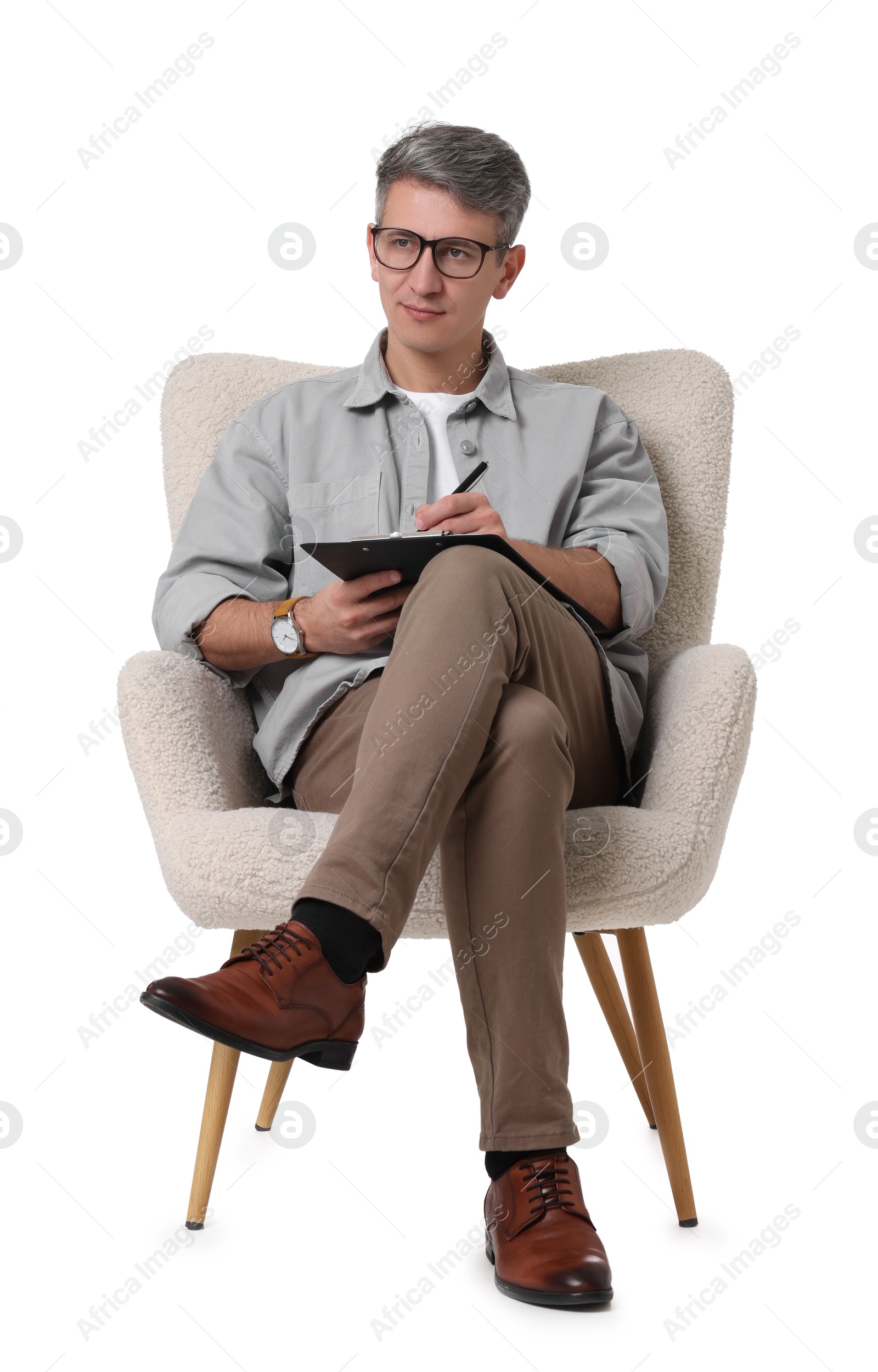 Photo of Professional psychologist with clipboard sitting on chair against white background