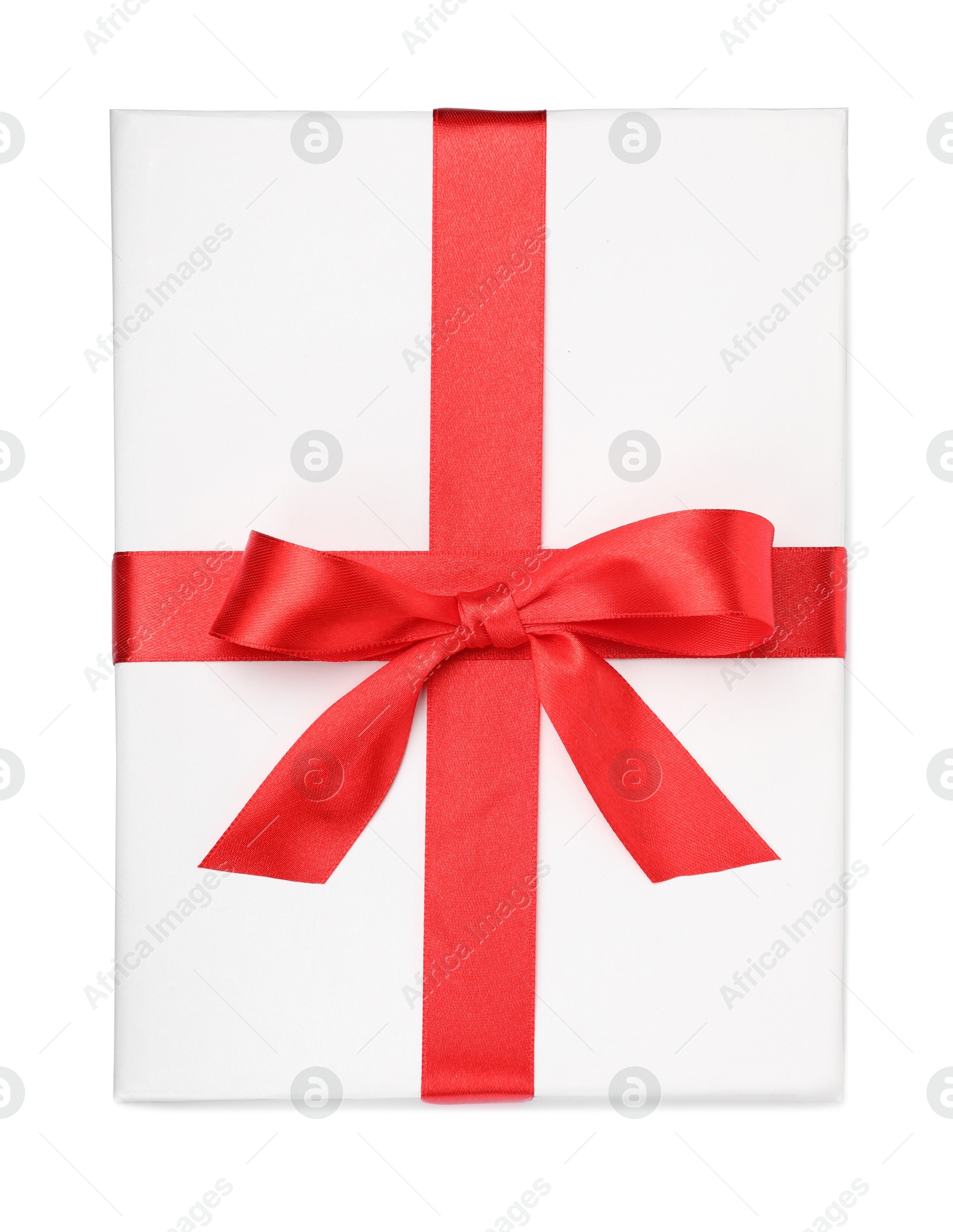 Photo of One book with red ribbon as gift isolated on white, top view