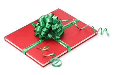 Photo of One book with green bow as gift isolated on white