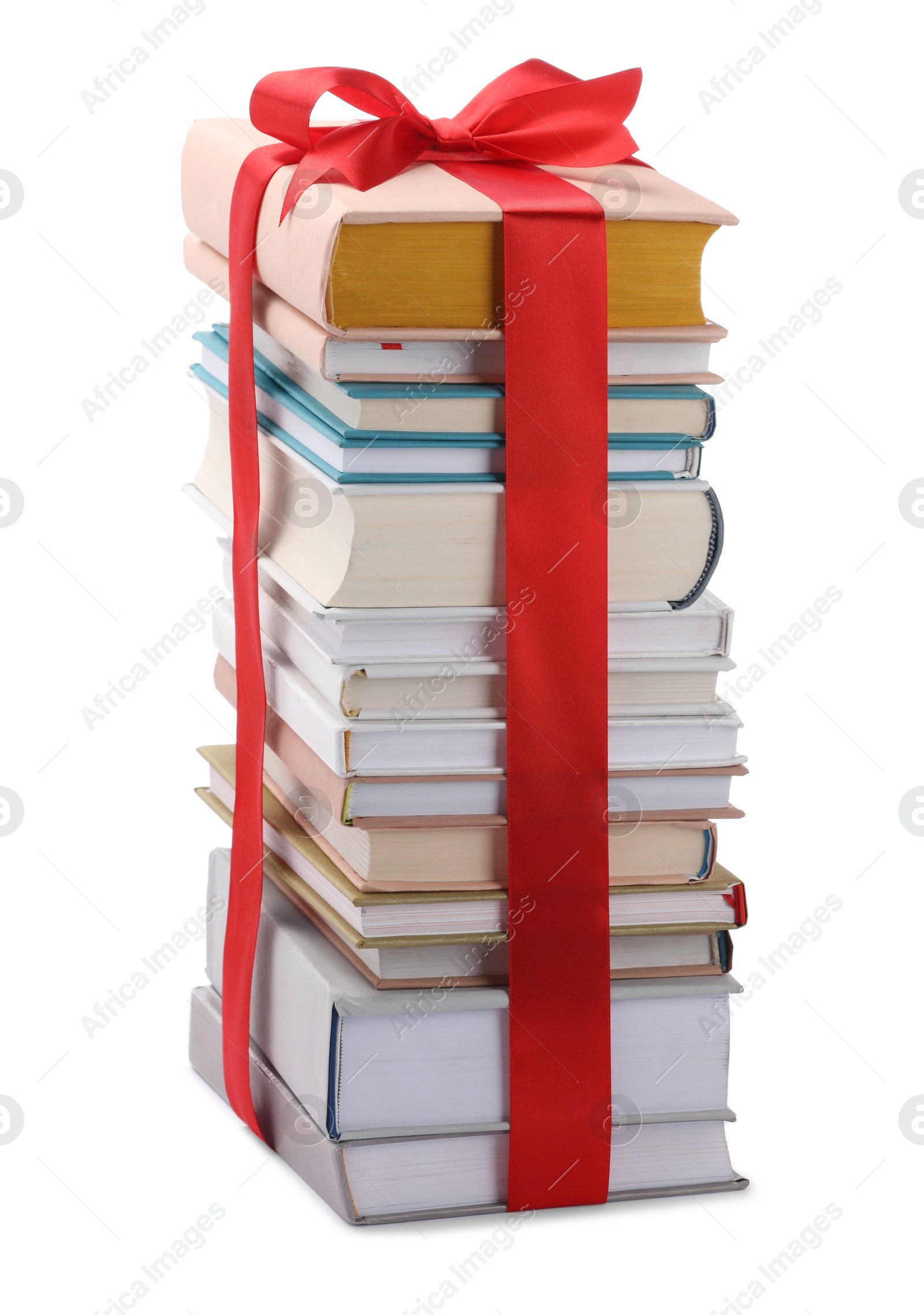 Photo of Stack of books with red ribbon as gift isolated on white