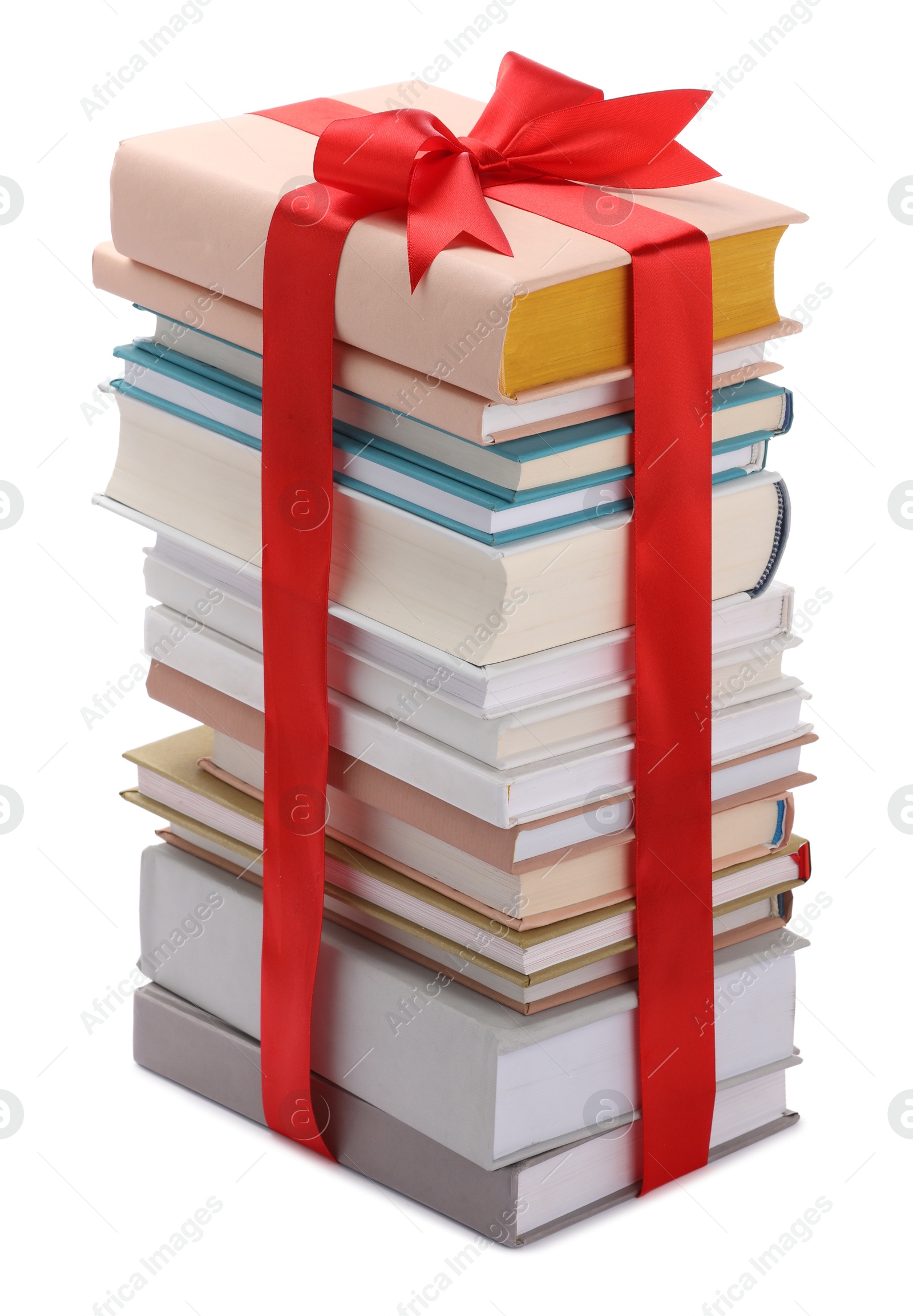 Photo of Stack of books with red ribbon as gift isolated on white