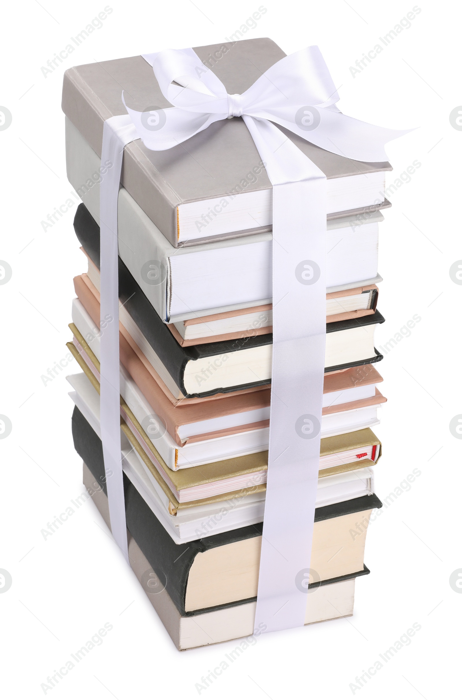 Photo of Stack of books with silk ribbon as gift isolated on white