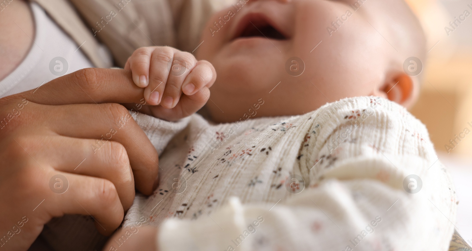 Photo of Mother with her cute little baby at home, closeup