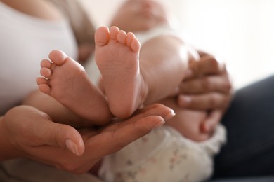 Photo of Mother with her cute little baby at home, closeup