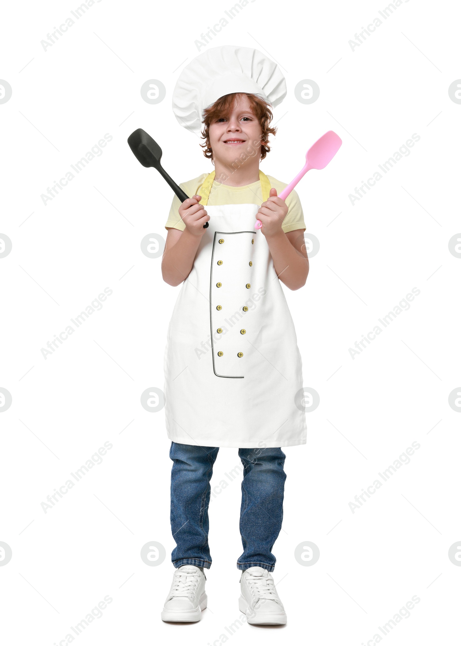 Photo of Little boy with utensils pretending to be chef on white background. Dreaming about future profession