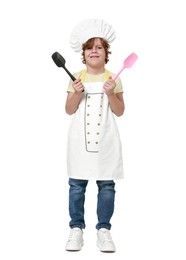 Photo of Little boy with utensils pretending to be chef on white background. Dreaming about future profession