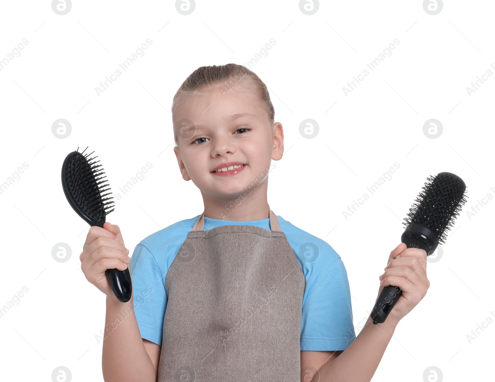 Photo of Little girl with brushes pretending to be hairdresser on white background. Dreaming of future profession