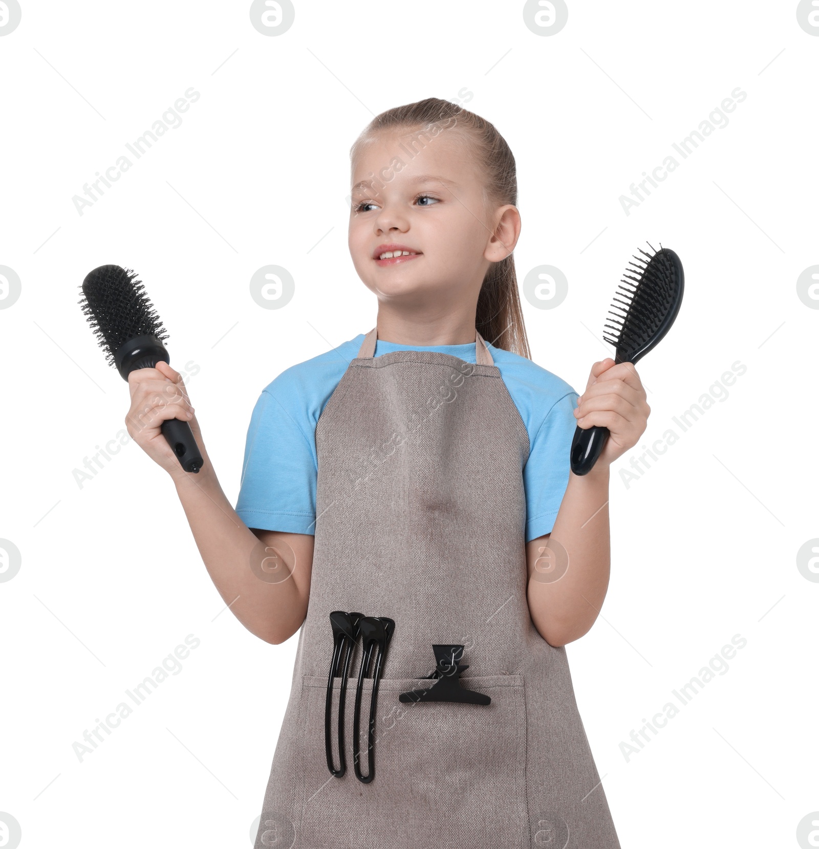 Photo of Little girl with brushes pretending to be hairdresser on white background. Dreaming of future profession