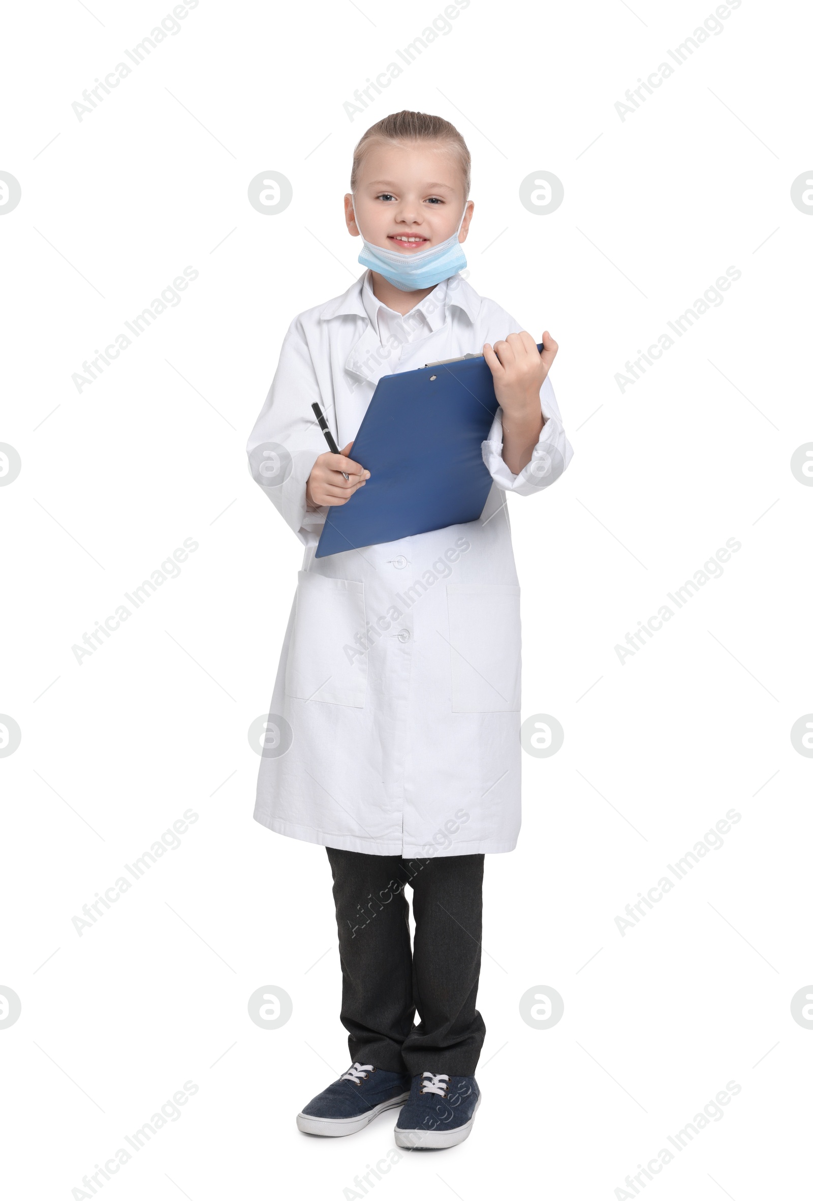 Photo of Little girl with protective mask and clipboard pretending to be doctor on white background. Dreaming of future profession