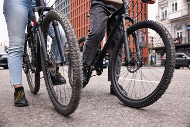 Photo of Couple with bicycles spending time together outdoors, closeup