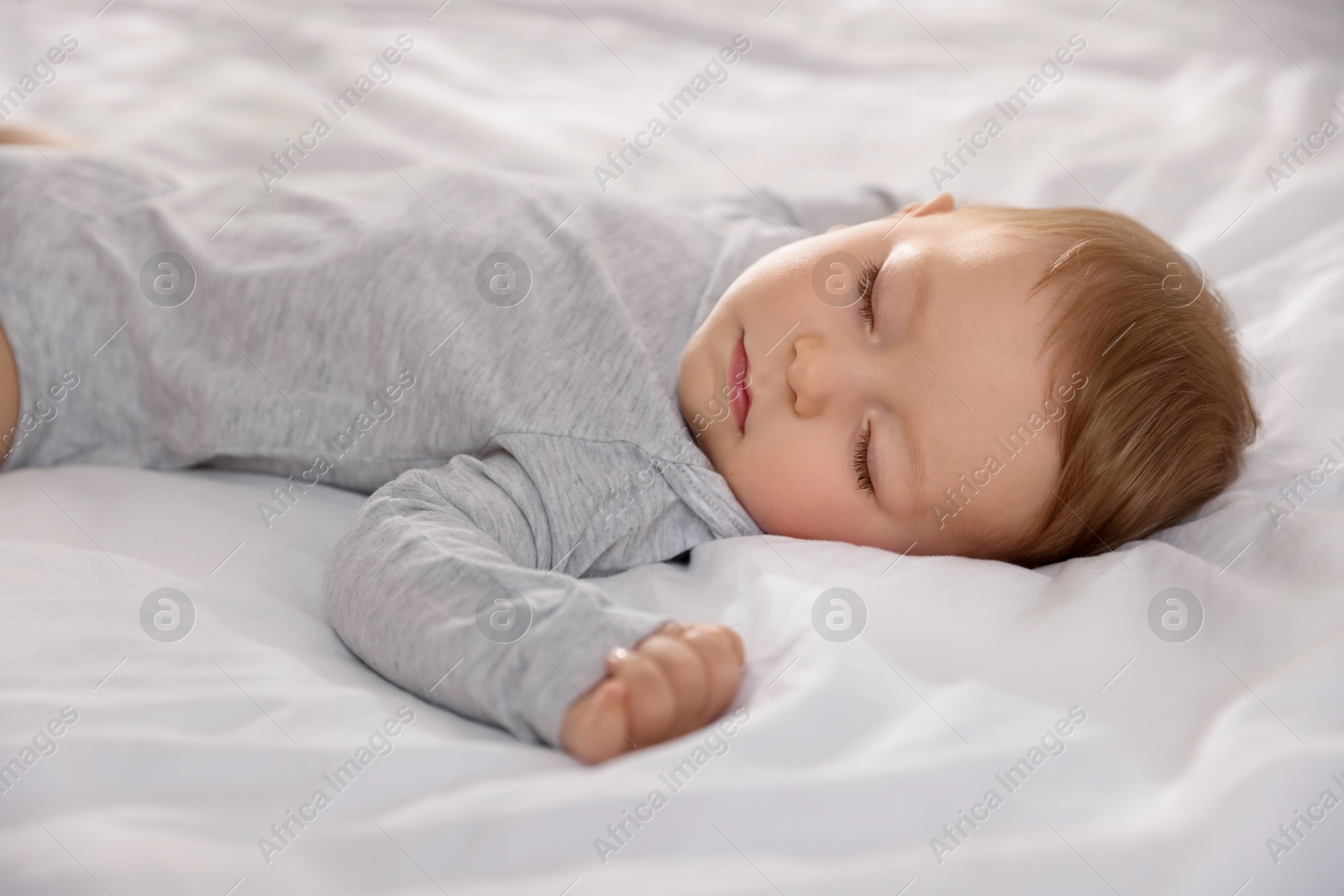 Photo of Cute little baby sleeping on bed at home