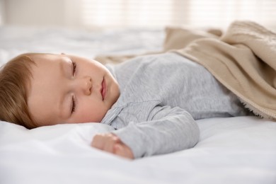 Photo of Cute little baby sleeping on bed at home