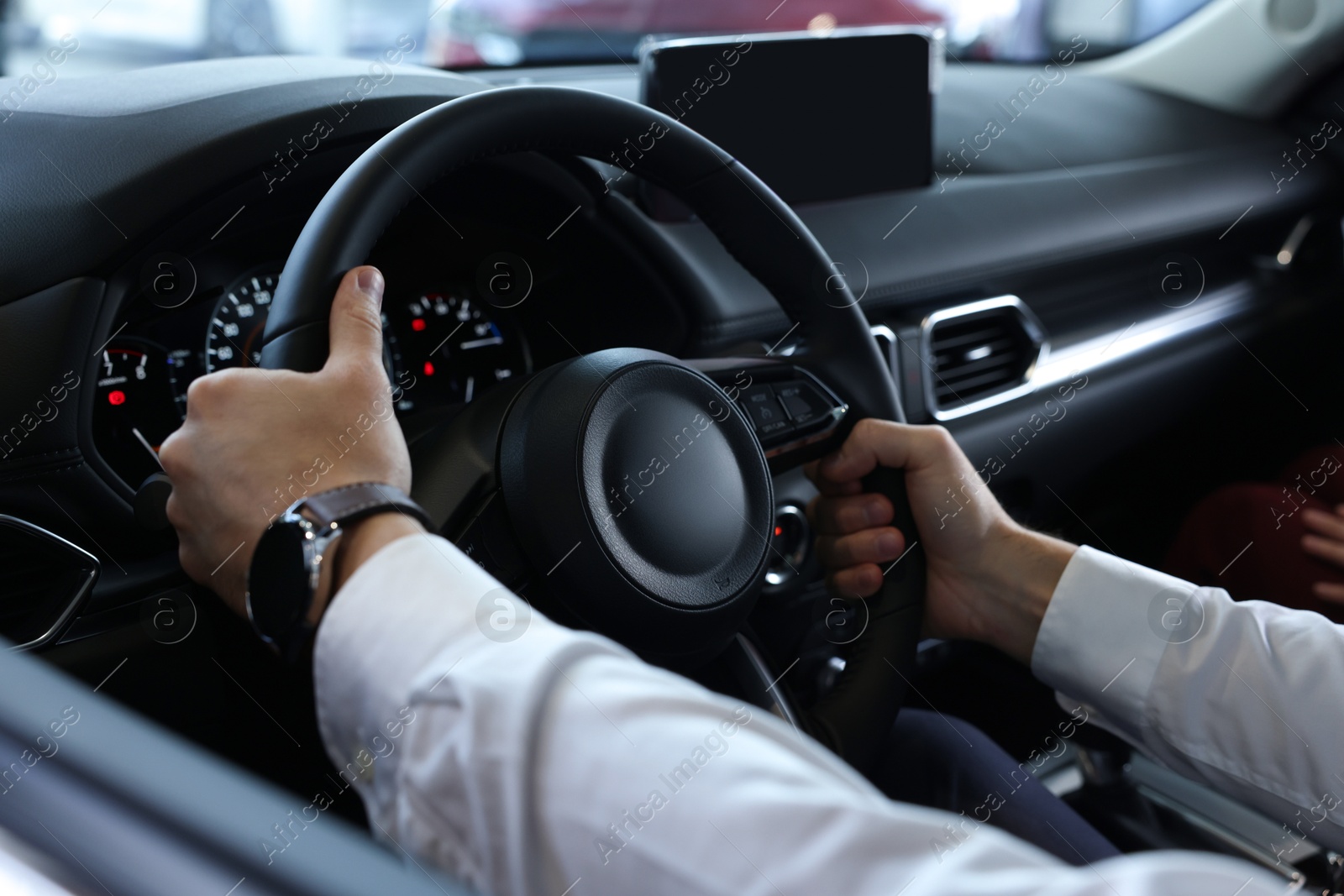 Photo of Man inside new car in salon, closeup