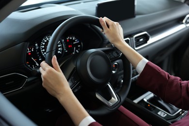 Photo of Young woman inside new car in salon, closeup