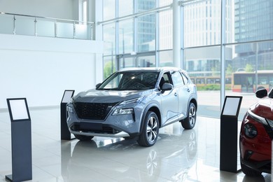 Photo of Luxury vehicle. New modern silver car in salon