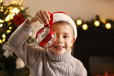 Little boy with Christmas ornament at home