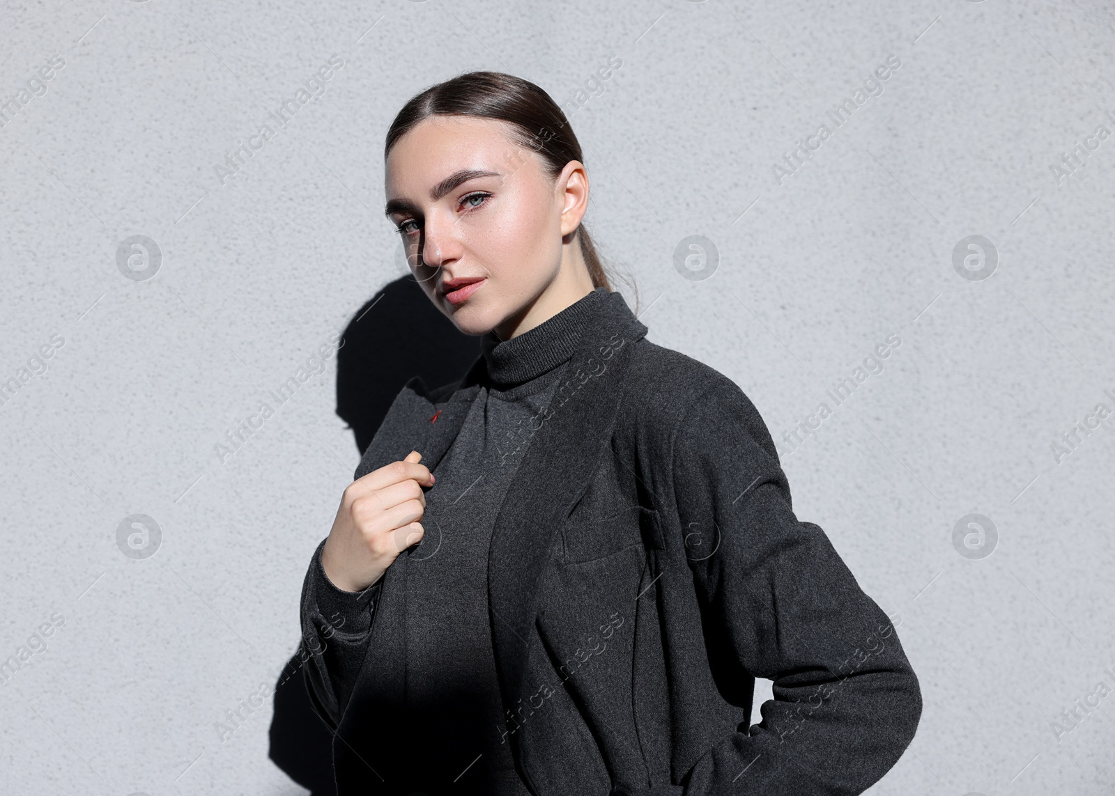 Photo of Beautiful young woman with posing on light grey background