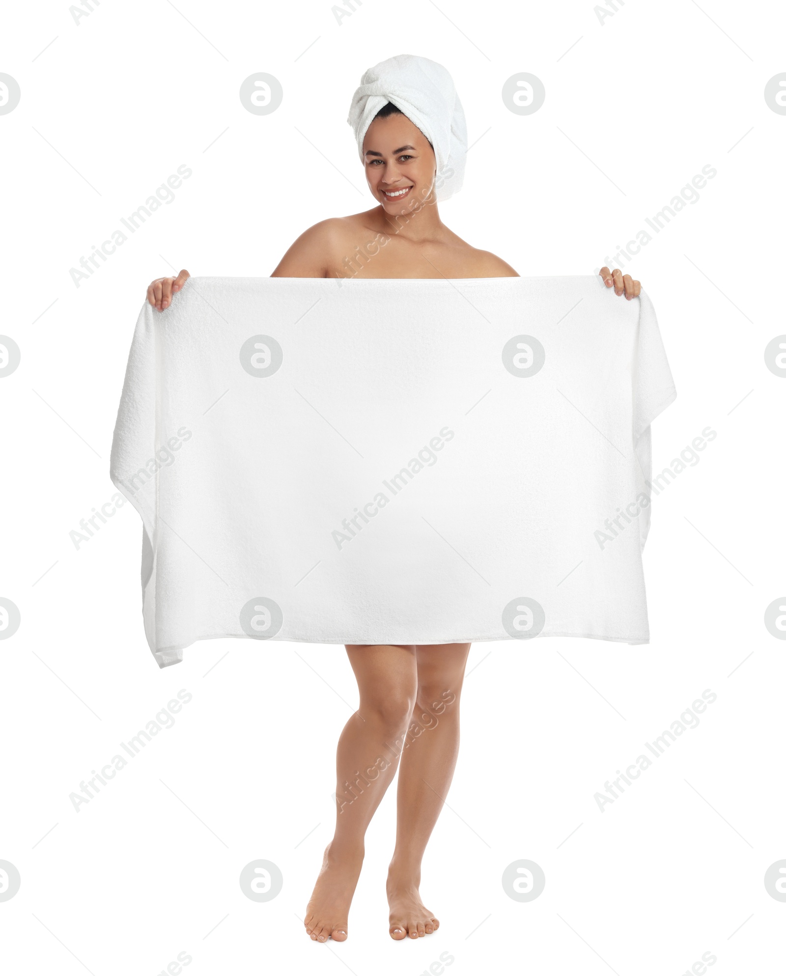 Photo of Beautiful young woman hiding behind towel on white background