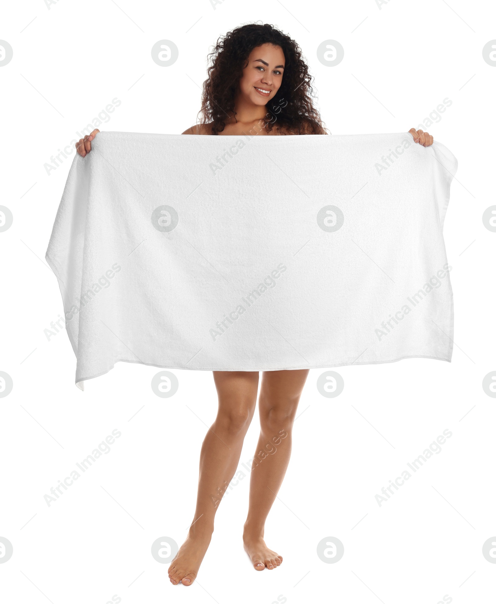 Photo of Beautiful young woman hiding behind towel on white background