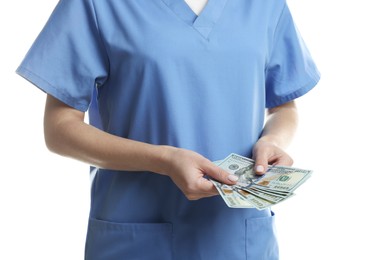 Photo of Corruption concept. Doctor with dollar banknotes on white background, closeup