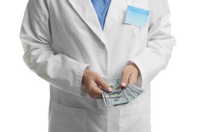 Photo of Corruption concept. Doctor with dollar banknotes on white background, closeup